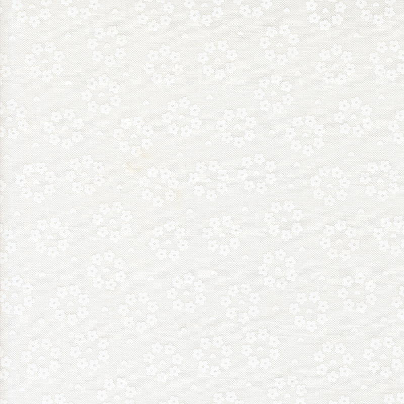 A contrasted scan of white-on-white fabric with small hearts surrounded by rings of flowers.