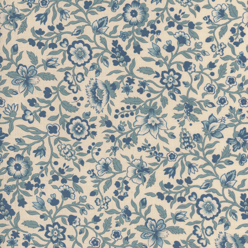 Cream fabric packed with blue leaves, vines, and florals