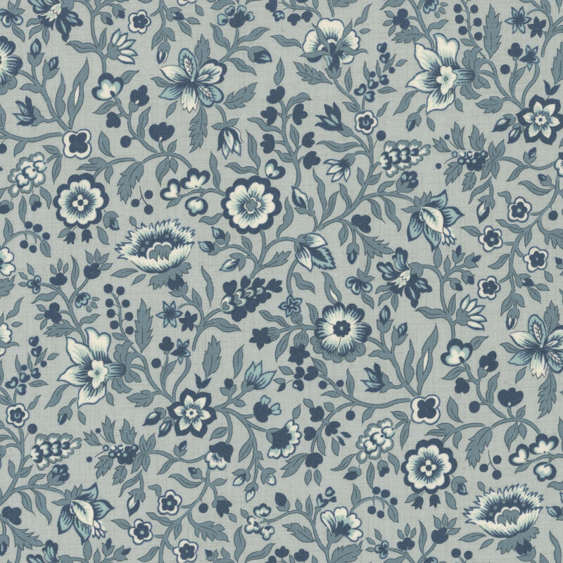 Blue fabric packed with leaves, vines, and florals