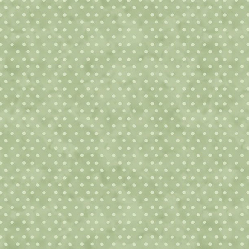 Sage green fabric featuring a light green polkadot pattern