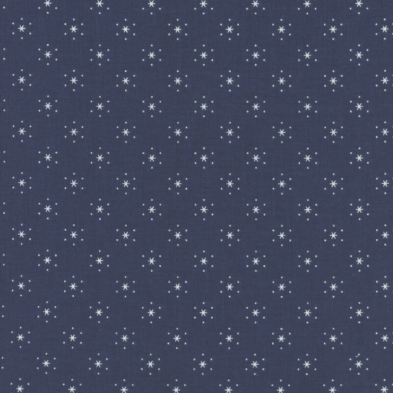 Denim blue fabric with small, white, evenly spaced stars that are surrounded by little white polka dots