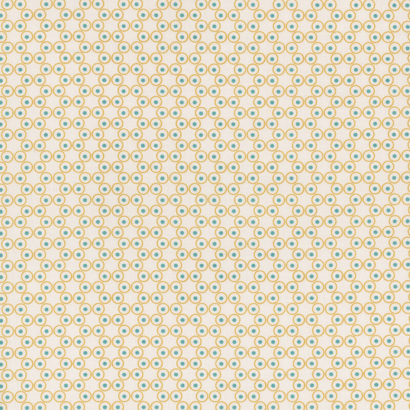 Off white fabric with small beige rings with blue dots in the centers arranged in a connected hexagon pattern