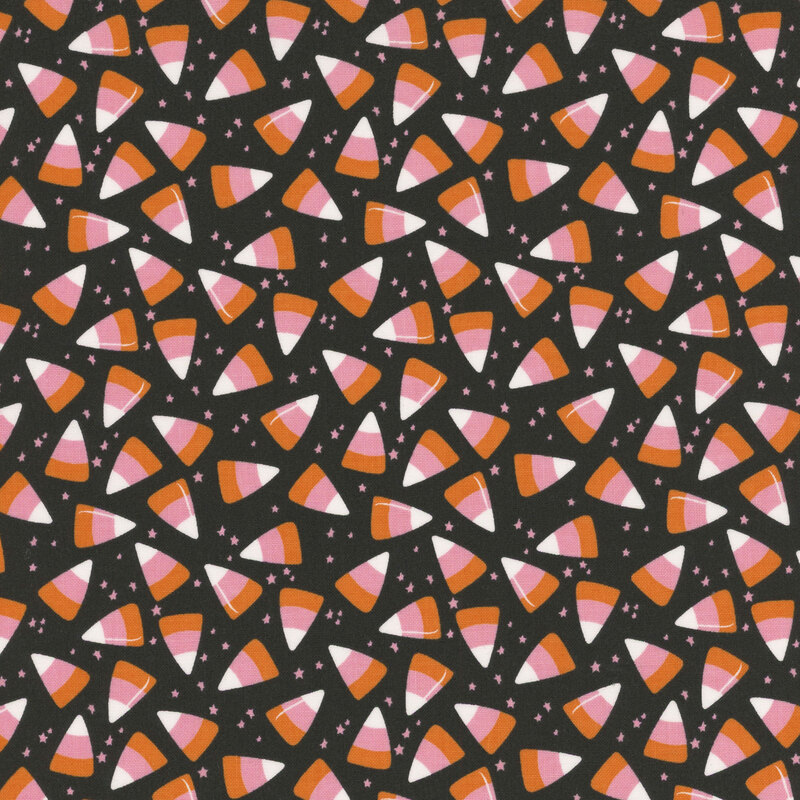 Black fabric with scattered candy corn and tiny white stars.