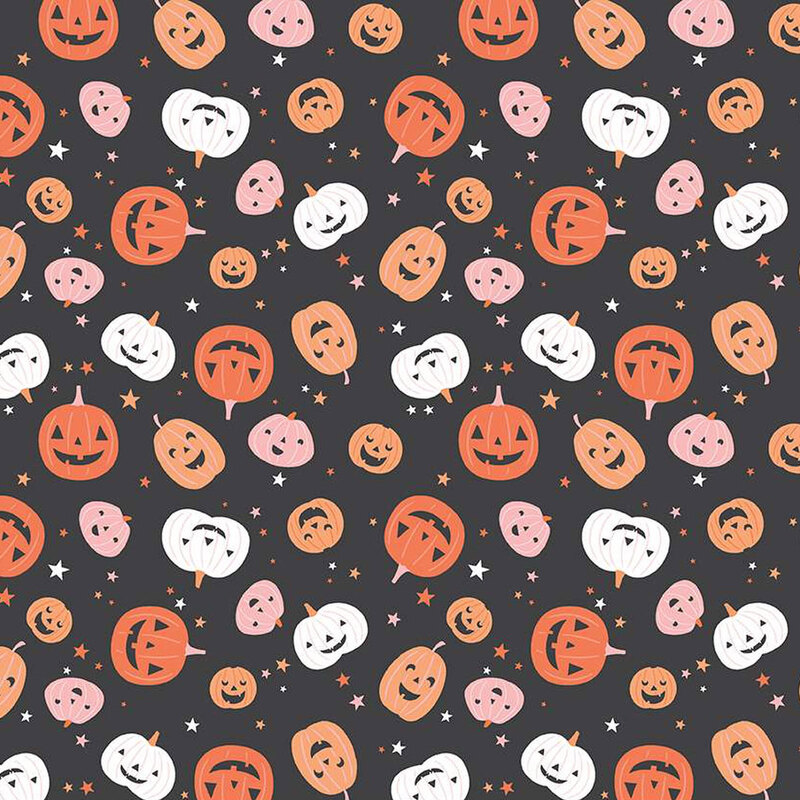 Black fabric with tossed jack-o-lanterns and stars.