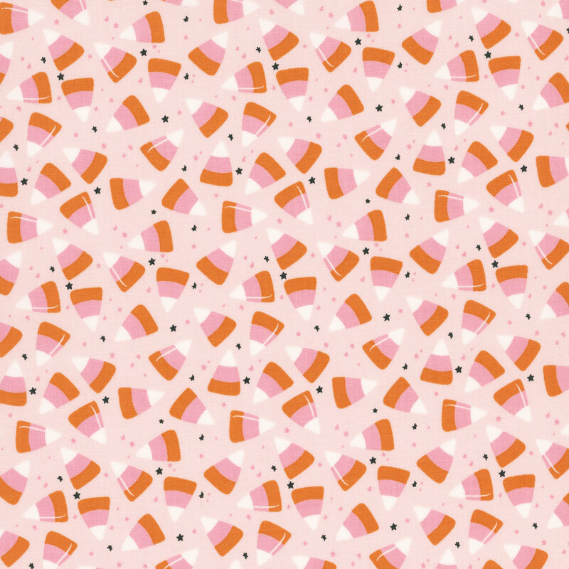 Blush pink fabric with scattered candy corn and tiny black and pink stars.