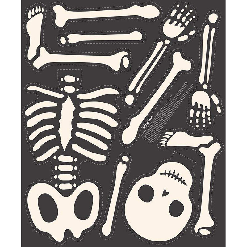 A black panel of a skeleton with outlines and instructions on where to cut and how to assemble.