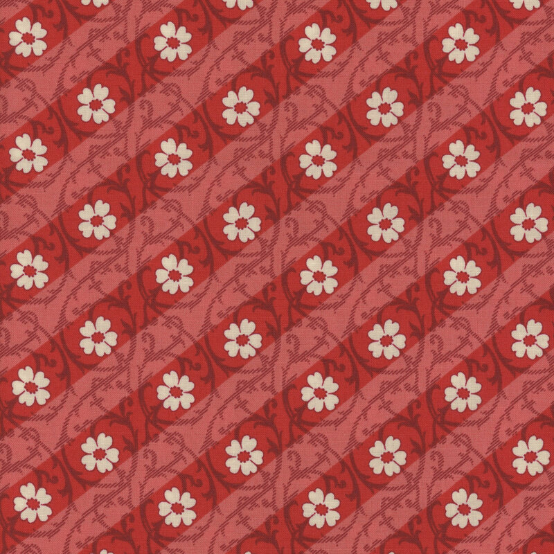 Red fabric featuring a diagonal striped design with florals and swirls