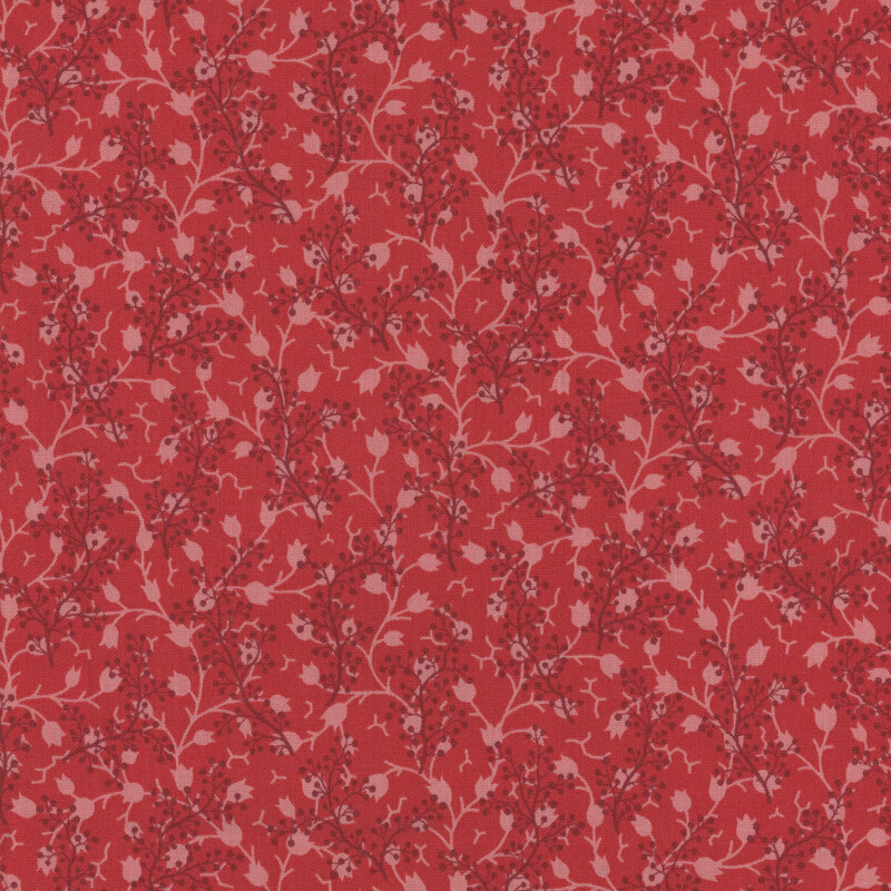 Tonal red fabric featuring a pattern of scattered sprigs intertwined with delicate floral vines