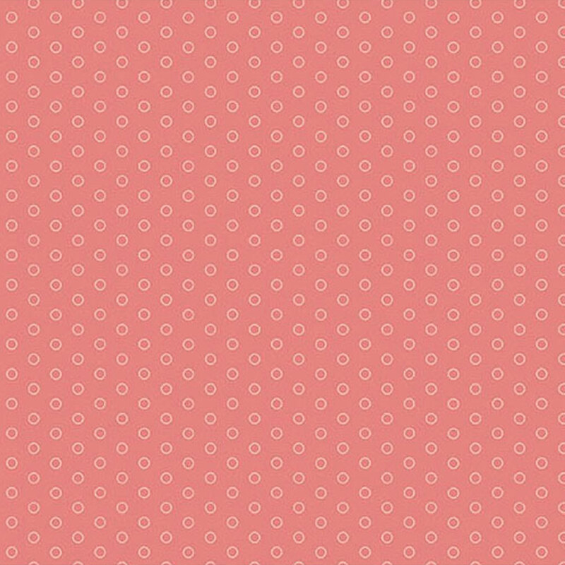 Pink fabric featuring lighter pink polka dots