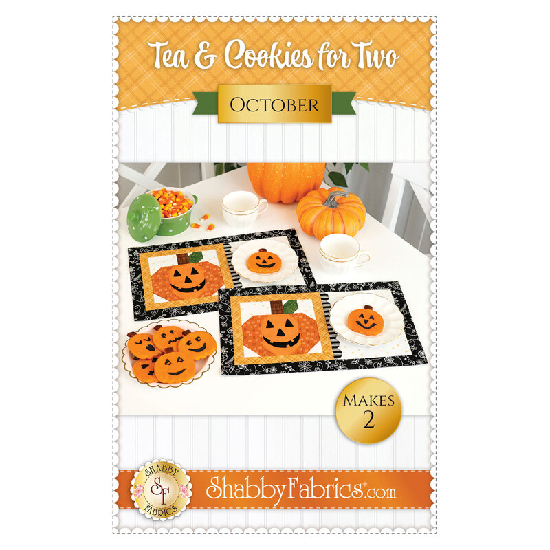 Front cover of the pattern featuring the two completed October mats in orange, black, and white, staged on a white table with coordinating decor with artfully frosted jack-o-lantern cookies.