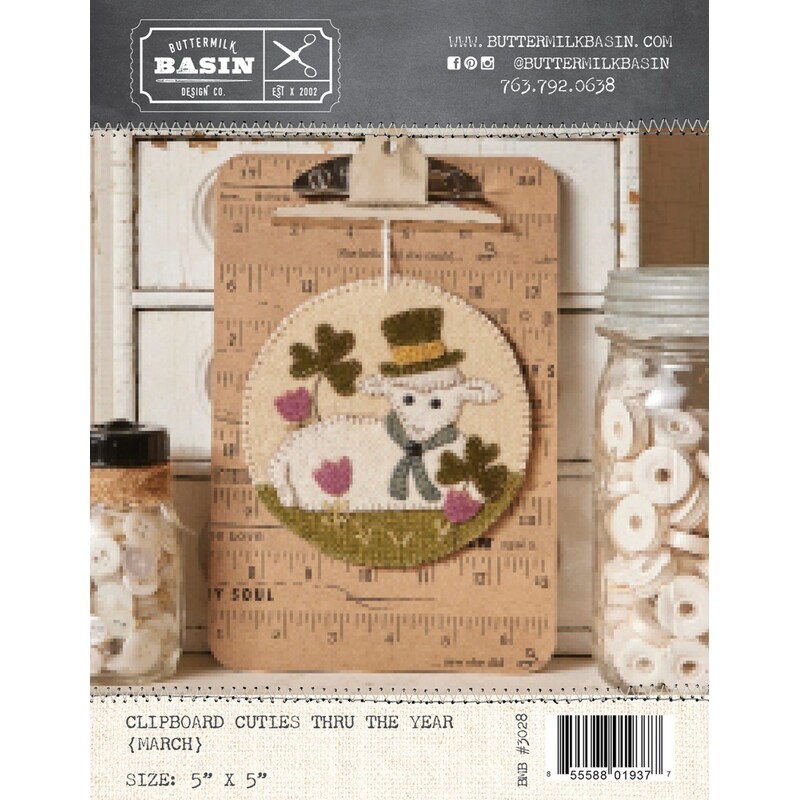 Front cover of the pattern showing the completed project staged on a clipboard surrounded by coordinating decor.