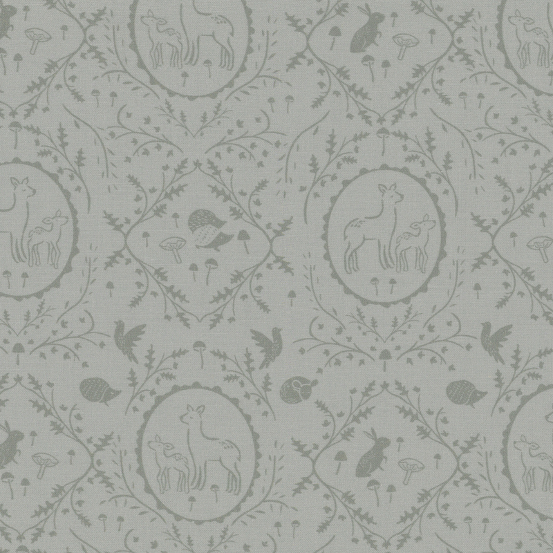 Sage gray fabric with tonal leaves and vines in a damask pattern surrounding forest animals.