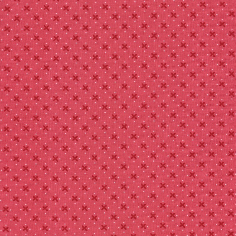 pink fabric with dark crosses and white dots