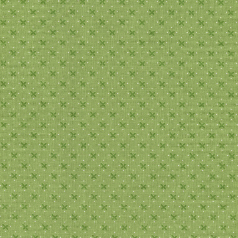 Lettuce green calico fabric adorned with dark crosses and white dots