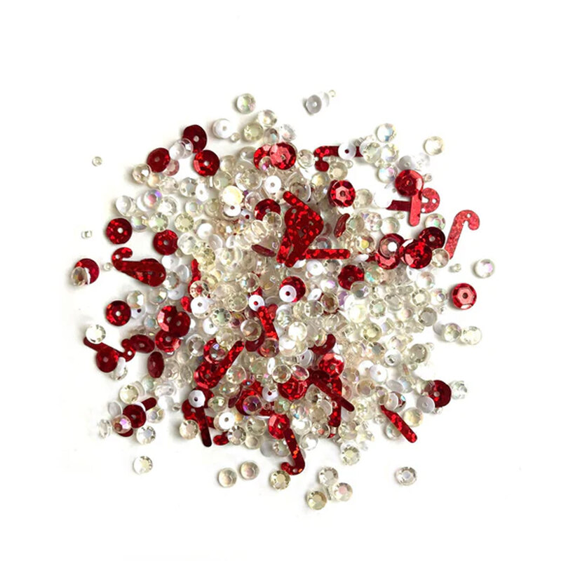 Pile of red and iridescent embellishments against a white background