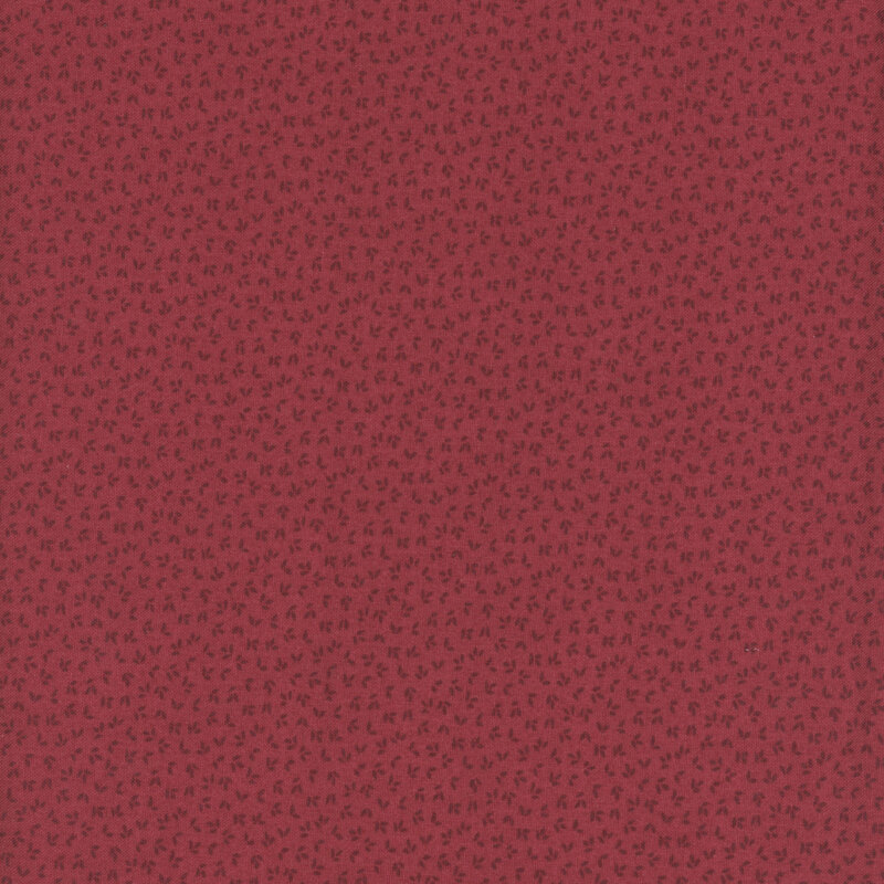 A apple red fabric with a tonal flower petal pattern