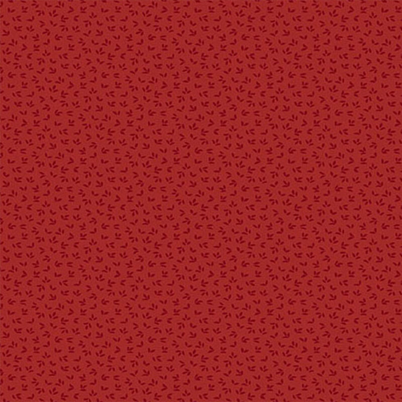 A apple red fabric with a tonal flower petal pattern