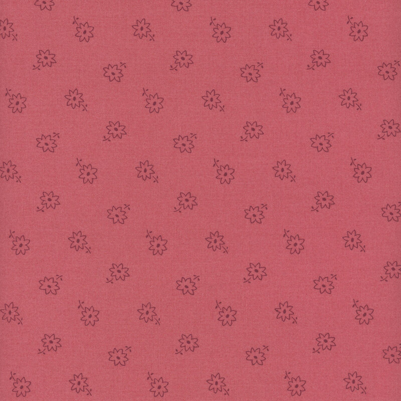 A rose pink fabric with a ditsy flower pattern