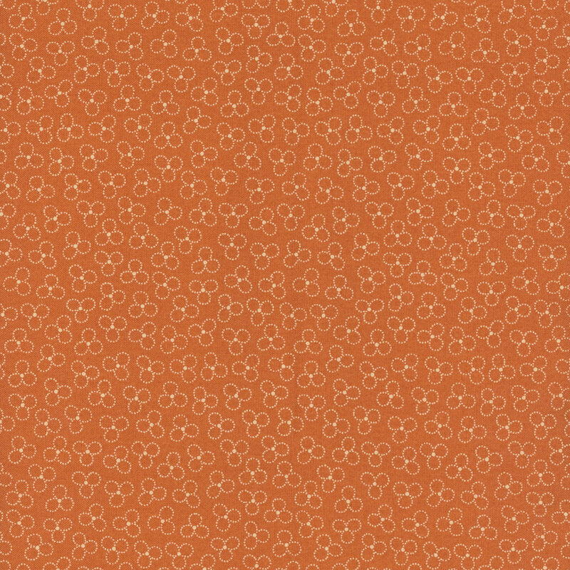 A orange fabric with a trefoil pattern