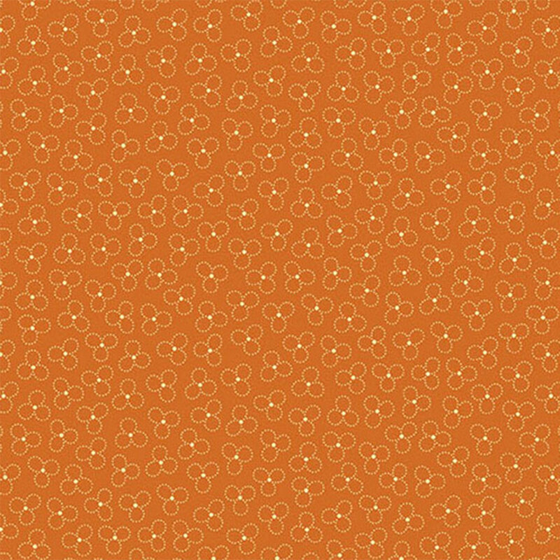 A orange fabric with a trefoil pattern