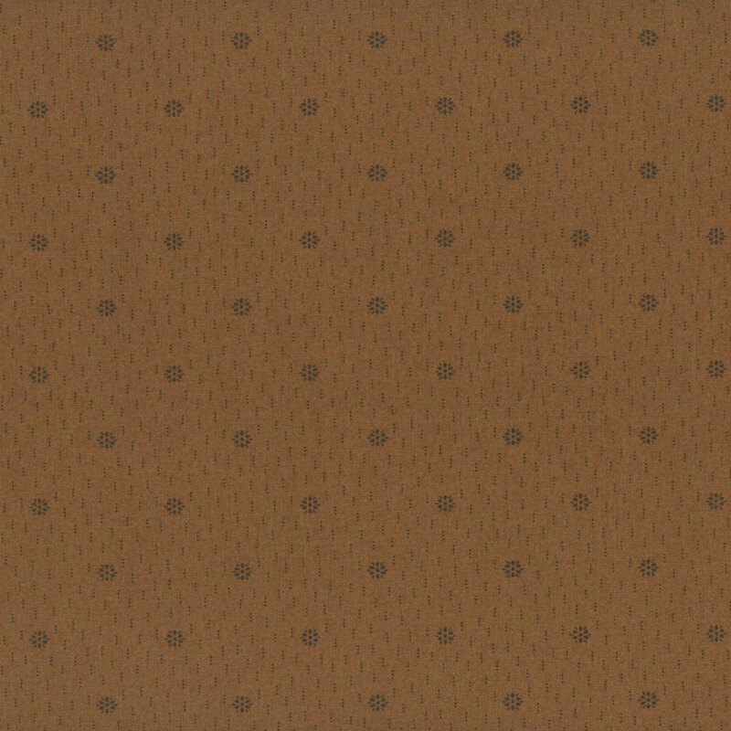 A fabric in a warm brown color with small, repeating dots and subtle lines.