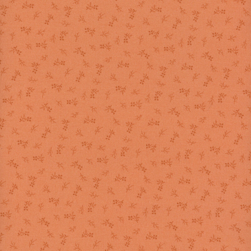 A fabric in a warm orange color with a subtle pattern of small, delicate flowers and branches.