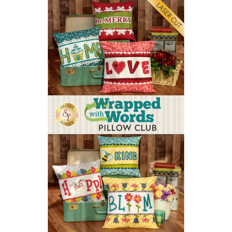 A promo image of the Wrapped with Words club, featuring six of the completed pillows, staged with a vintage suitcase and coordinating decor.