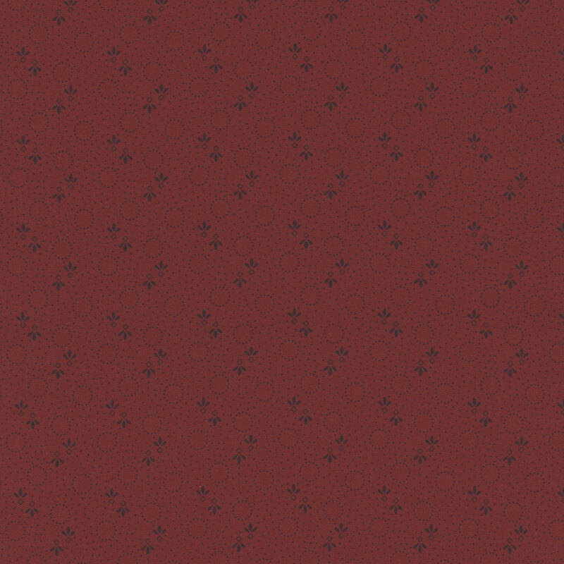 Repeating pattern of small dark dots, and floral designs on a dark red background.