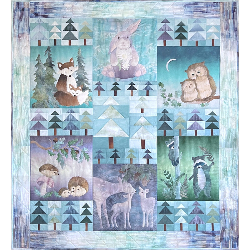 Patchwork quilt with woodland animals, trees, and a rabbit in a blue winter scene.