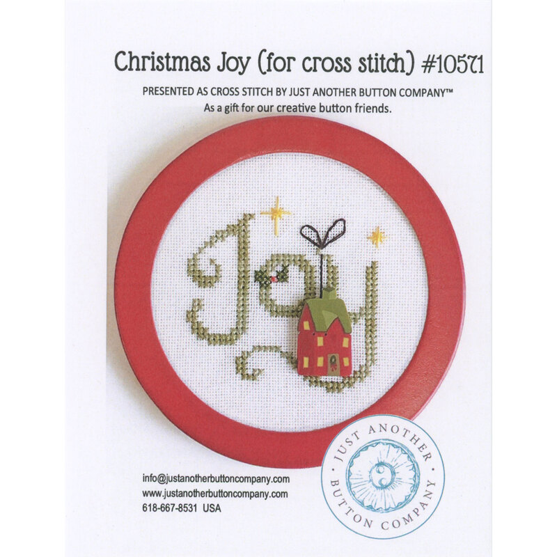 Front of the pattern featuring a circular cross-stitch design with the word Joy and a small house, framed in red.