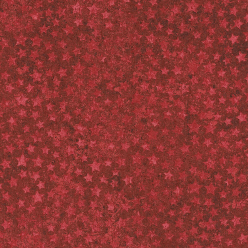 Red fabric with a pattern of overlapping dark and light red stars.