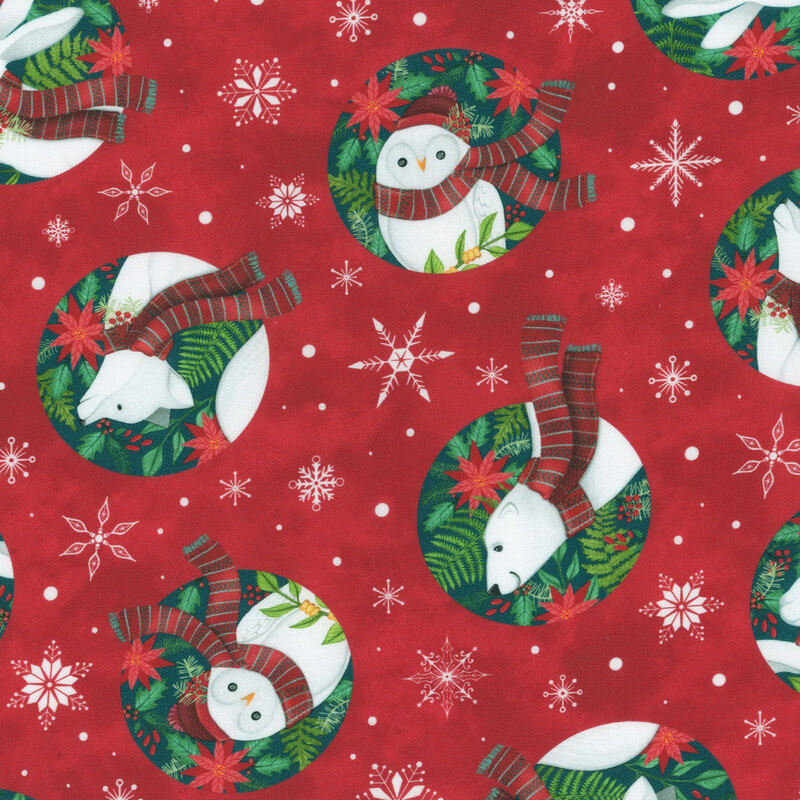 Red fabric featuring snowmen, rabbits, and wreaths on a snowflake background.