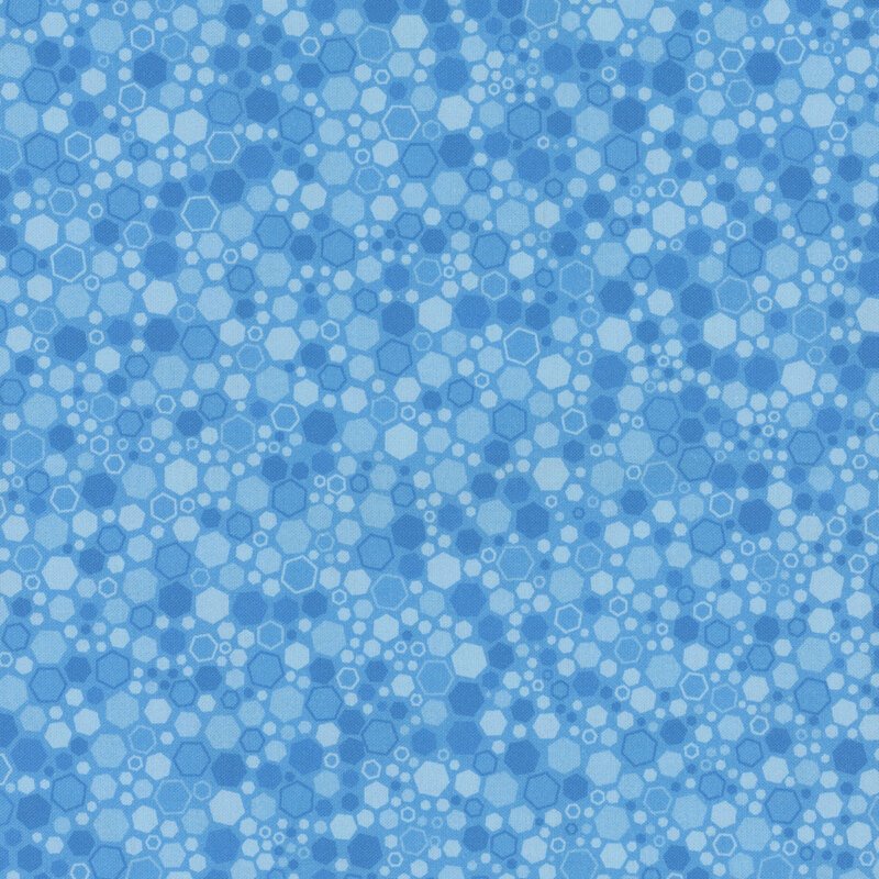 A blue fabric featuring various overlapping circles and hexagons in lighter shades.