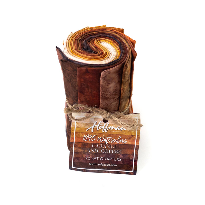 Rolled fabric bundle labeled Caramel and Coffee, featuring 12 fat quarters in brown tones.