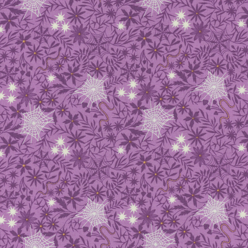 A purple patterned fabric featuring white spiderwebs and various flowers and leaves.