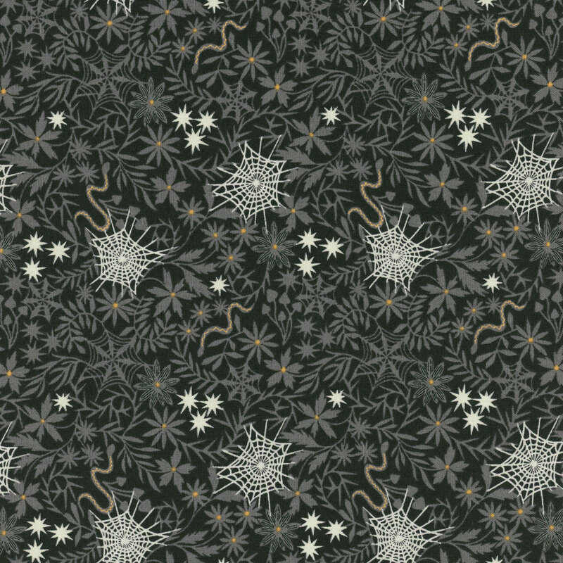 A black patterned fabric featuring white spiderwebs and various flowers and leaves.