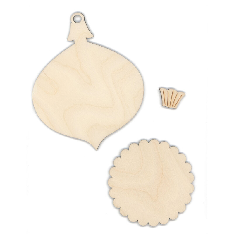 Three blank wooden craft shapes: an ornament, a scalloped circle, and a small decorative piece, isolated on a white background.