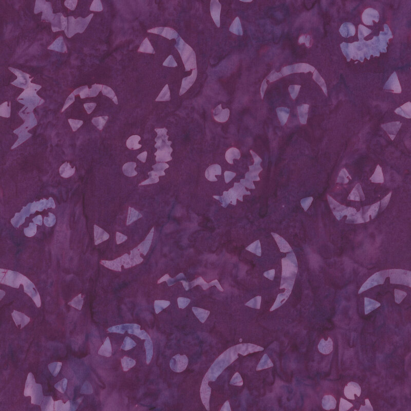 A purple background adorned with various playful Halloween-themed faces and patterns.