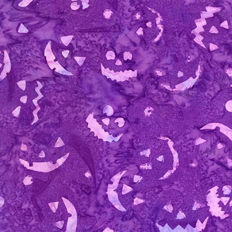 Purple mottled fabric with light purple smiling jack-o-lantern faces