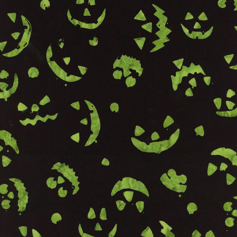 Pattern of various green Halloween-themed jack-o'-lanterns on a black background.