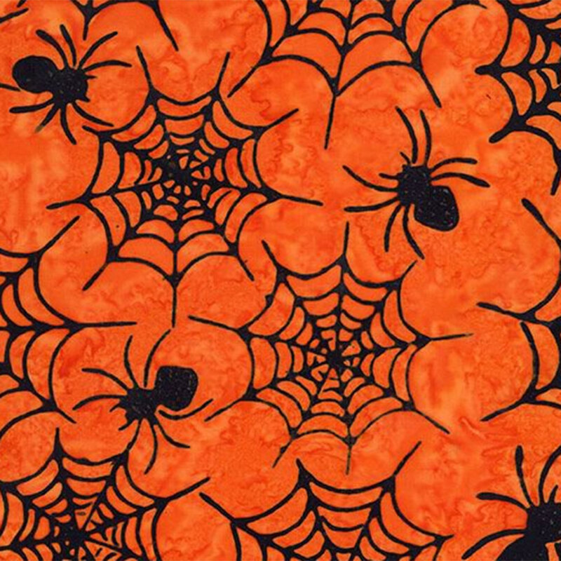 Bright orange mottled fabrics with black outlines of spiders and spider webs