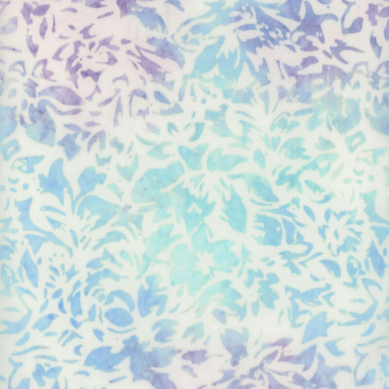 A floral batik featuring intricate purple and aqua designs layered over an off white background.