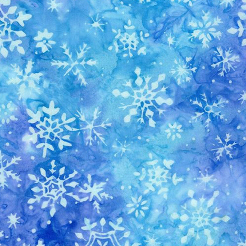 Blue and purple mottled batik fabric with light blue snowflakes scattered throughout