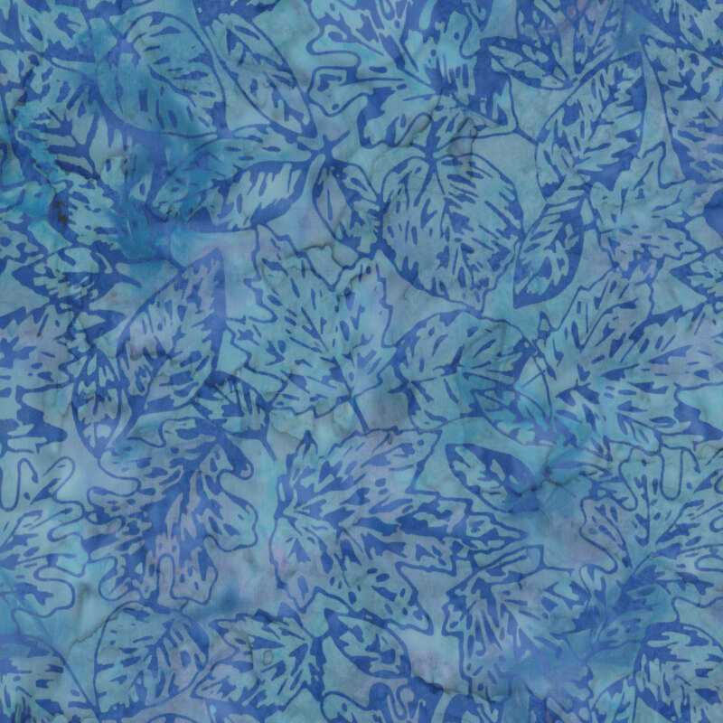 A fabric with blue maple leaves overlapping on a textured light blue background.