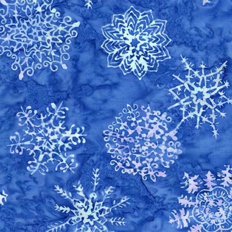 A textured blue batik scattered with various intricate white snowflake designs.