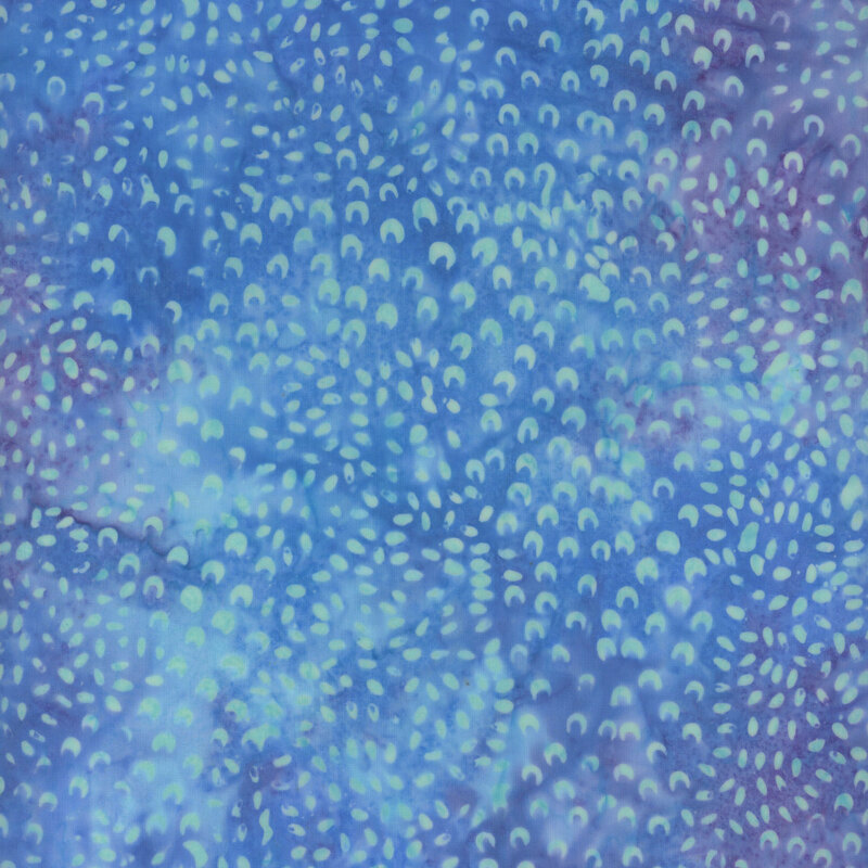 Abstract batik pattern featuring blue hues with lighter crescent shapes scattered throughout.