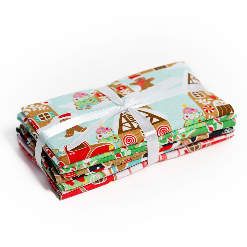 Colorful Christmas fabric bundles tied with white ribbon, featuring festive designs.