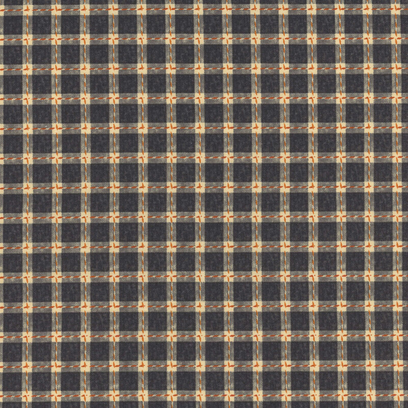 Black, cream, and orange plaid fabric