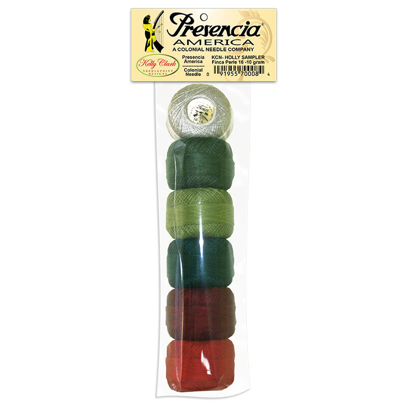 Six balls of perle cotton floss packaged in an array of warm Christmas colors, isolated on a white background.