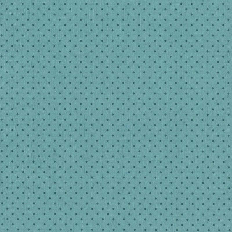teal fabric with a repeating pattern of small dark blue dots.